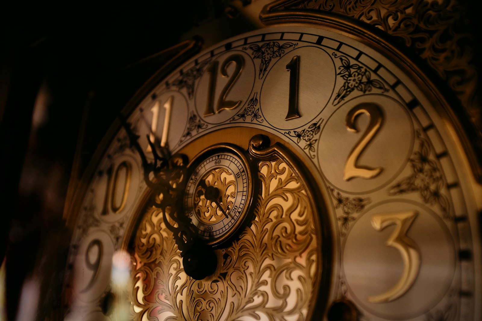 Close-up of an antique grandfather clock face in warm low light