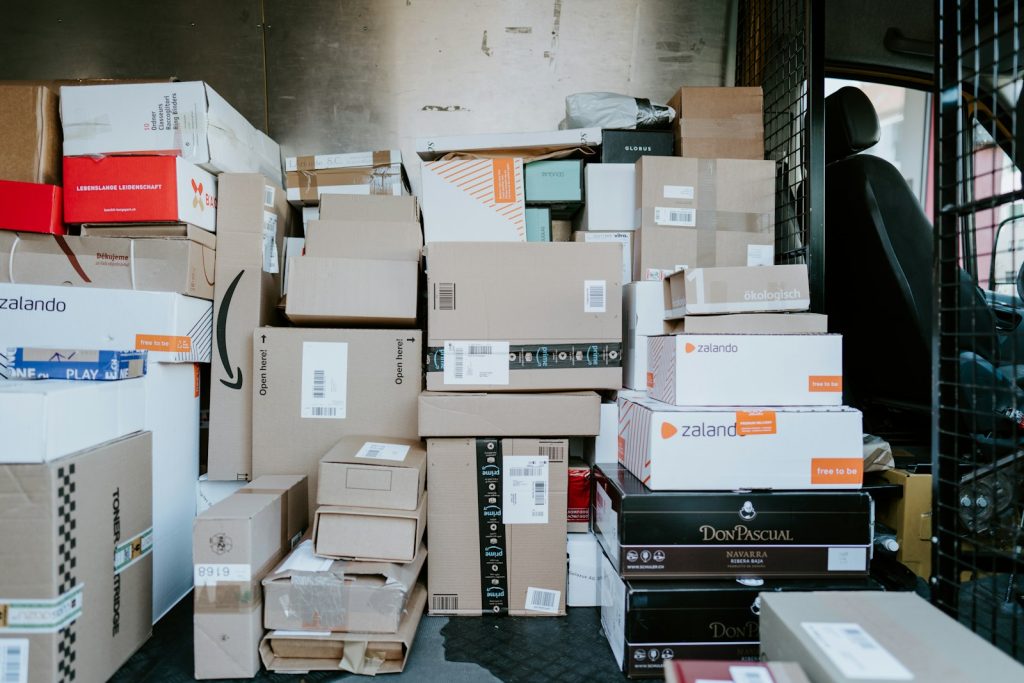 Stack of cardboard shipping boxes inside the back of a delivery van