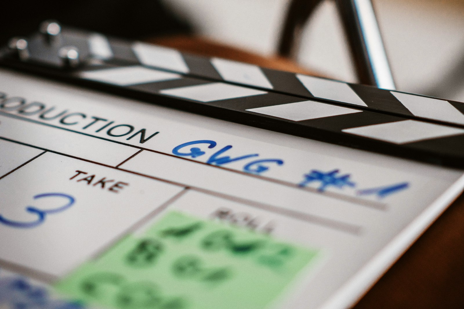 Close-up of a black and white film clapperboard marked Take 3 on a movie set
