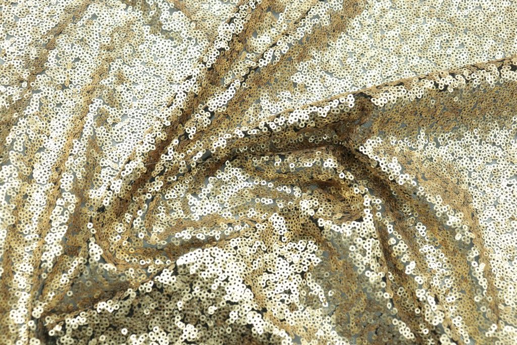Close-up of shimmering gold sequin fabric as used for evening gowns