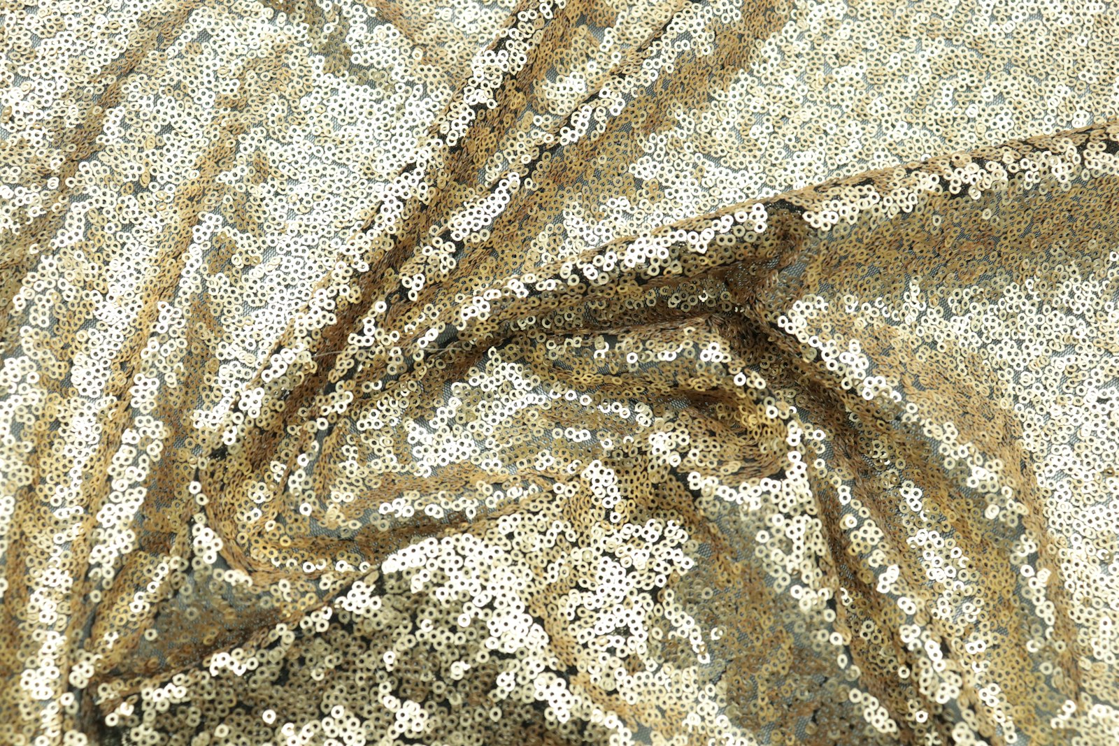 Close-up of shimmering gold sequin fabric as used for evening gowns
