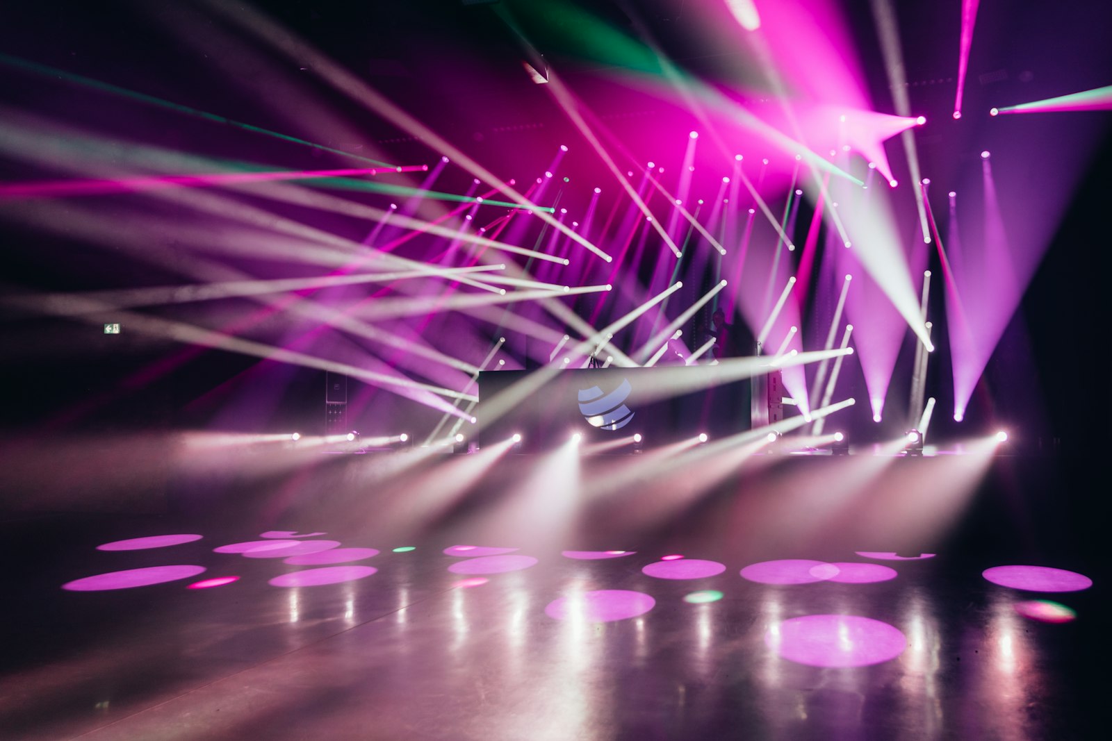 Empty concert stage bathed in purple and blue spotlights