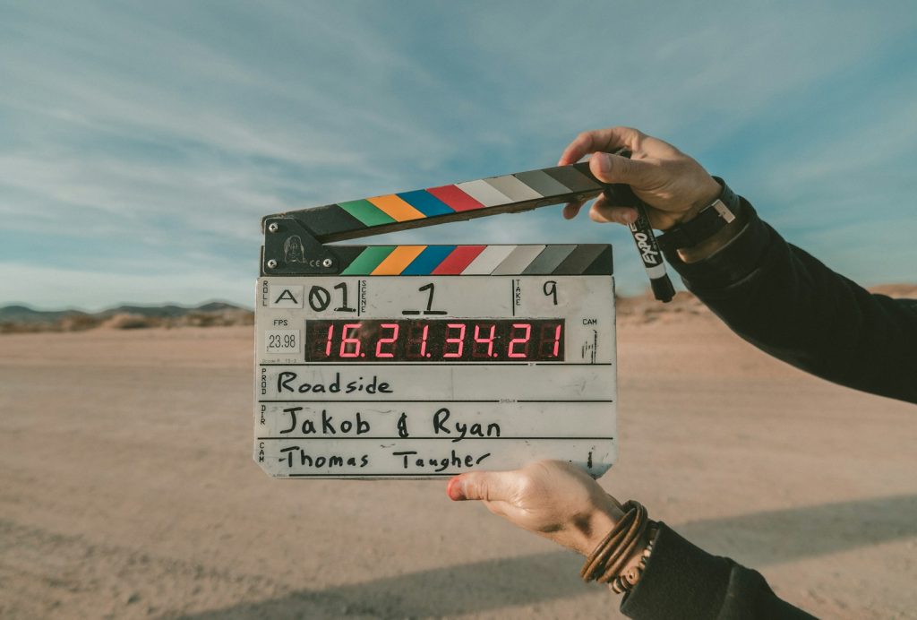 A film clapperboard held up outdoors at the start of a take, symbolising working actors and the film industry