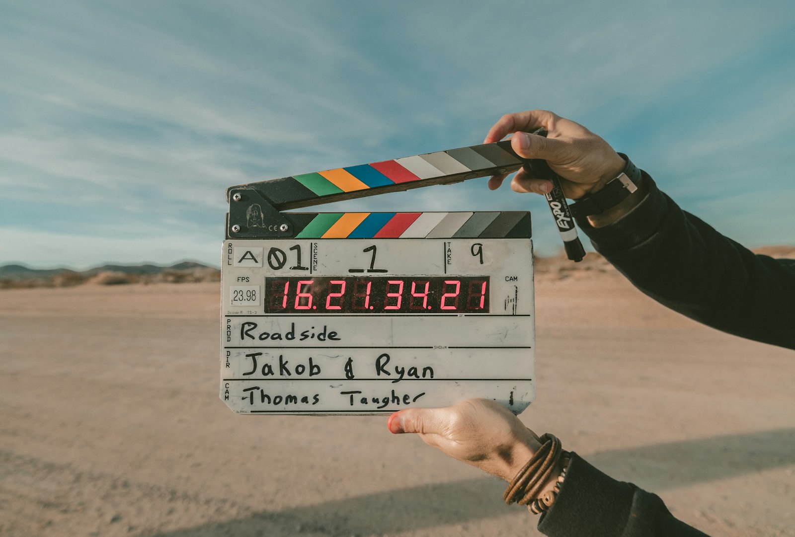 A film clapperboard held up outdoors at the start of a take, symbolising working actors and the film industry